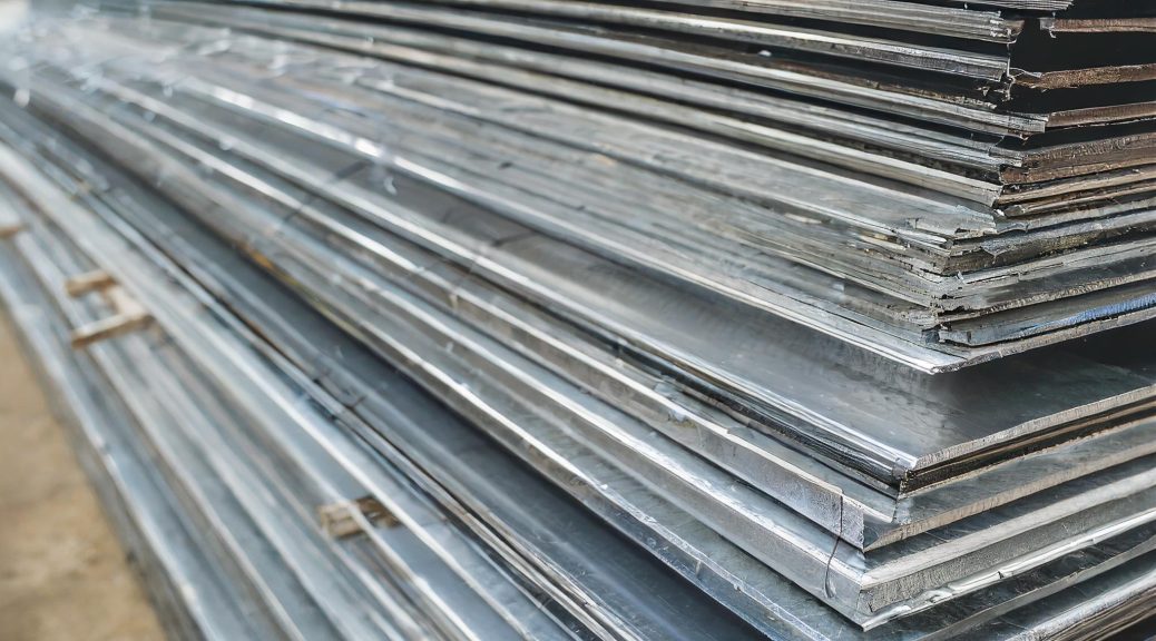 stack of aluminum sheeting in various thicknesses inside warehouse